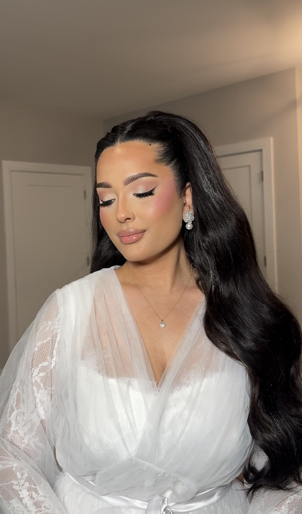 Refined bridal makeup with softly closed eyes